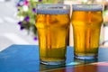 French cold beer in misted glasses served on outdoor terrace in small Alpine village in France