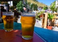 French cold beer in misted glasses served on outdoor terrace in small Alpine village in France