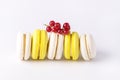 French Colorful Macarons White and Yellow Macarons on White Background with Fresh Red Currant Horizontal Dessert