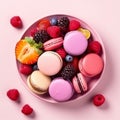 French colorful macaroons on a plate. Pink background.