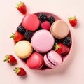 French colorful macaroons on a plate. Pink background.