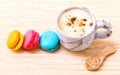 French colourful macaroons and a cup of coffee.