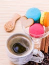 French colourful macaroons and a cup of coffee.