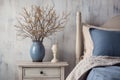 French country bedroom interior. Vintage vase and lamp on the nightstand in rustic style. Neutral blue, grey and white colors Royalty Free Stock Photo