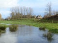 Country scene showing trees and river after rain