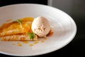 French crepe with fresh sweet orange sauce baked almond and vanilla ice cream Royalty Free Stock Photo