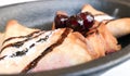 French crepes with chocolate sauce and cherries in a reastaurant in Paris, pancakes recipe Royalty Free Stock Photo