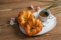 French croissants and a cup of coffee on the wooden table. Nice morning breakfast. Food template, top view Royalty Free Stock Photo