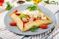 French cuisine. Breakfast, lunch, snacks. Pancakes with egg poached, feta cheese, fried ham, avocado Royalty Free Stock Photo