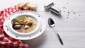 French seafood soup with white fish, shrimps and mussels in plate at wooden background Royalty Free Stock Photo