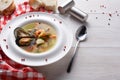 French seafood soup with white fish, shrimps and mussels in plate at wooden background Royalty Free Stock Photo