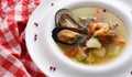 French seafood soup with white fish, shrimps and mussels in plate at wooden background Royalty Free Stock Photo