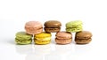 French dessert for coffee. alined multicolored macarons on white background