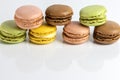 French dessert for coffee. Close up alined multicolored macarons on white background