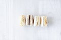 French dessert macarons filled with dark and white chocolate,lemon ganache,powered with cocoa powder in line Royalty Free Stock Photo