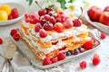 French dessert Mille Feuille with custard cream and strawberries on ceramic plate, powdered with sugar