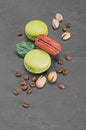 French dessert. Sweet chocolate and pistachio macaroons or macarons with coffee beans and nuts