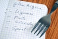 French diet plan concept with a list written in a notebook next to a fork close up Royalty Free Stock Photo