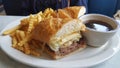 French dip sandwich with french fries and au jus Royalty Free Stock Photo