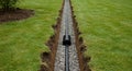 French Drain Installation in Green Lawn Efficient water drainage system erosion control landscape improvement perforated pipe