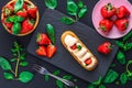 French eclair grazed with chocolate and fruity strawberry cream or sweet Italian profiteroles and fresh juicy strawberries, food