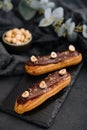 french eclairs with chocolate and hazelnuts