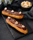 french eclairs with chocolate and hazelnuts