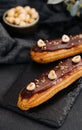 french eclairs with chocolate and hazelnuts