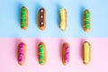 French eclairs on pink and blue backgrounds.