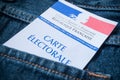 French electoral card in blue jeans pocket