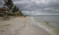 French Families enjoying a day out on Port Gentil beach in the Rainy Season Royalty Free Stock Photo