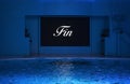 French Fin word meaning the End on the screen display above a pool at night.