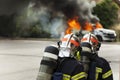 French firefighter binomial attac on car fire Royalty Free Stock Photo