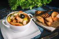 French fish soup Bouillabaisse with seafood, salmon fillet, shrimp, rich flavor, delicious dinner in a white beautiful Royalty Free Stock Photo