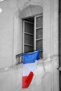 French Flag Hanging on the Window of a Building Royalty Free Stock Photo