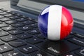 French flag on laptop keyboard. Online business, education, shopping in France concept. 3D rendering