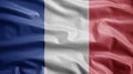 French flag waving in the wind. Close up of France banner blowing soft silk