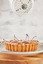 French Flair, cherry clafoutis presented on white marble dusted with powdered sugar Royalty Free Stock Photo