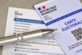 French form for a proxy vote with an electoral card and a pen