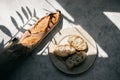 French fresh bread baguette with slices on a ceramic plate on gray background. Royalty Free Stock Photo