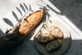 French fresh bread baguette with slices on a ceramic plate on gray background. Royalty Free Stock Photo