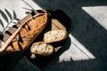 French fresh bread baguette with slices on a ceramic plate on gray background. Royalty Free Stock Photo