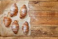 French fresh crusty croissants on a wooden table top view Royalty Free Stock Photo