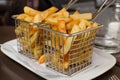 French fried potatoes on frying basket