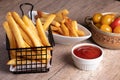 French fries in a black basket with tomato sauce Royalty Free Stock Photo