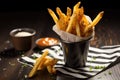 french fries in a black and white striped cone