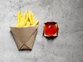 French fries in the brown paper wrapper with sauce isolated with abstract background. with copy space Royalty Free Stock Photo