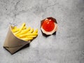 French fries in the brown paper wrapper with sauce isolated with abstract background. with copy space Royalty Free Stock Photo