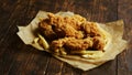 French fries and chicken wings on parchment