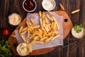 French fries chips potato and sauces on wooden background. top view Royalty Free Stock Photo